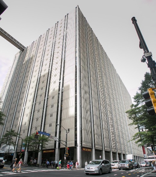 Photo of a busy street corner next to a large modern building